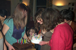 Friends holding birthday cakes